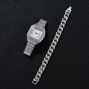 Close-up of silver square watch with Roman numerals and matching iced-out Cuban bracelet