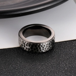 Macro detail of 8mm silver-black men's titanium steel ring with hammered texture
