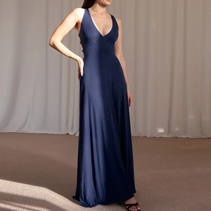 Detail of elegant navy blue halter neck maxi dress with backless cut and flowing fabric