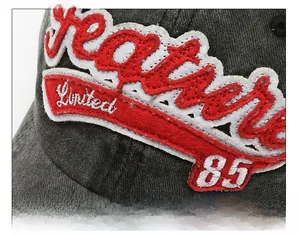 Close-up of premium 3D embroidery with Limited 85 text on washed denim baseball cap