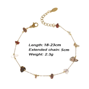 Macro shot of gold beaded bracelet featuring crushed stones and adjustable clasp details