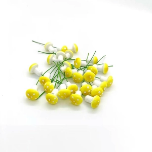 Miniature yellow foam mushrooms with white dots and wire stems for DIY decor