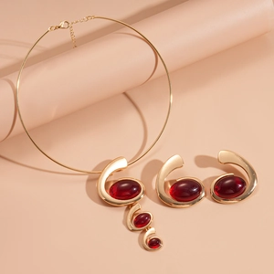 Golden geometric collar necklace and earrings set with red oval resin stones