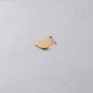 Detailed top view of a gold bird-shaped pendant with a polished mirror finish