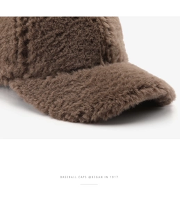 Macro view of plush brown faux shearling texture on a warm winter baseball cap