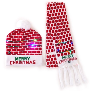 Close-up of LED glowing knit Christmas hat and scarf set with Merry Christmas text