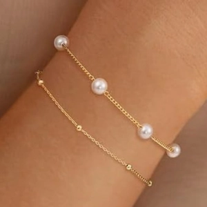 Elegant layered gold bracelet with pearls and beads for women, minimalist luxury style
