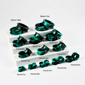 Silicone ear gauges with green and black swirl patterns from 8mm up to 38mm