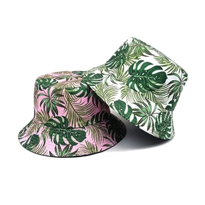 Reversible bucket hat with tropical palm leaf prints in pink and white canvas fabric
