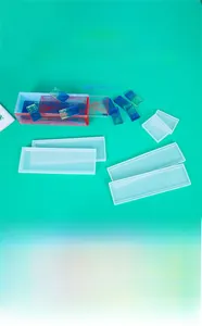 Translucent silicone mold for domino storage box with blue resin pieces on green base
