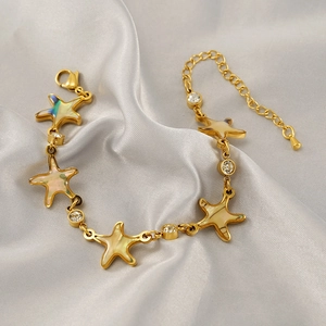 Gold stainless steel star bracelet with mother-of-pearl inlays and sparkling crystals