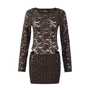 Close-up of black long sleeve lace dress with sequins and waist cut-out details