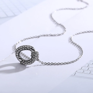 Irregular hollow silver pendant necklace with crystals on a modern steel chain