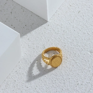 Macro view of 18K gold plated ring with oval seal face and twisted rope band detail