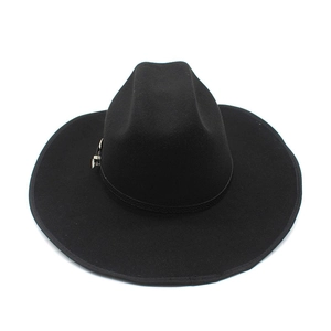 Detailed close-up of black felt cowboy hat texture with decorative band and buckle
