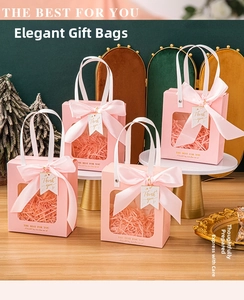 Pink paper gift bags with clear window, large satin bow, and Thank You tag in a set of four