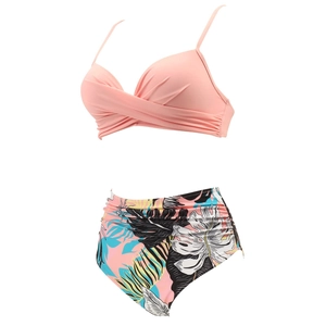 Detail of pink twist-front bikini top and high-waisted tropical leaf print bottoms