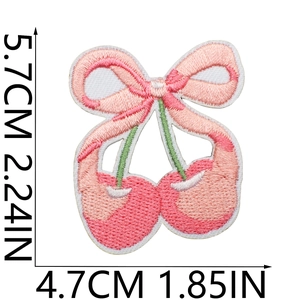 Detail showing embroidered cherry bow patch with dimensions 5.7cm x 4.7cm for clothing