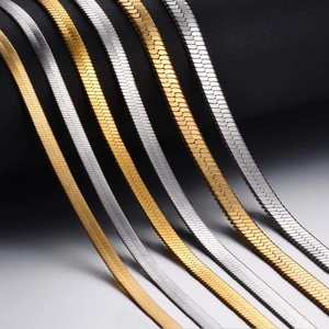 Close-up of gold and silver flat snake bone chains in stainless steel for jewelry