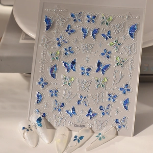3D butterfly nail stickers with metallic blue texture and glitter for French manicure art