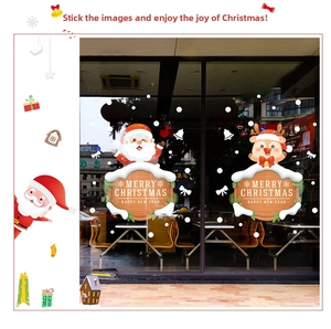 Close-up of Santa Claus and cartoon reindeer Christmas static window stickers on glass