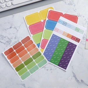 Close-up of colorful planner sticker set with months and tasks on marble desk