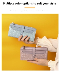 Detail of crocodile embossed long wallet with multi-card slots and secure snap closure
