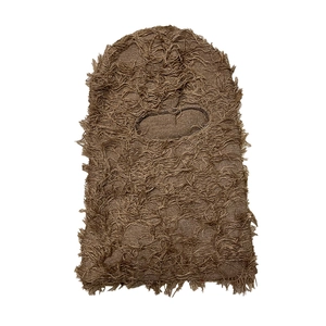Detail of brown knitted balaclava showing distressed fringe texture and coarse wool fabric