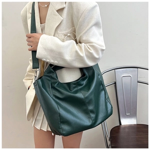 Detail of dark green PU leather hobo tote showing large capacity and soft texture