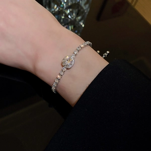Detail of adjustable silver bracelet featuring square-cut zircon and paved diamonds