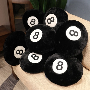 Plush black 8-ball billiards cushions piled on a sofa showcasing soft texture and design