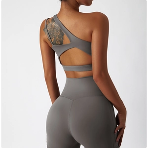 Detail view of the asymmetric open-back design on this charcoal grey yoga sports bra