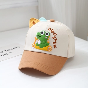 Detail of cartoon dinosaur embroidery and ear decoration on toddler baseball cap
