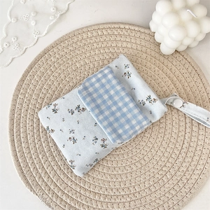 Close-up of a floral print nurse pocket protector and storage bag with blue plaid patterns