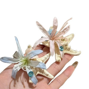 Starfish hair clip with fabric flower and rhinestone detail for beach vacation style
