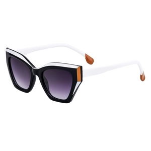 Cat eye sunglasses with black and white frames, orange accents, and purple gradient lenses