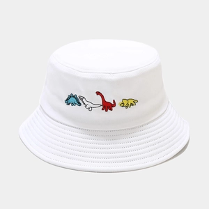 Close-up of white cotton bucket hat featuring colorful embroidered dinosaur and stitching