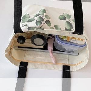 Top view of white canvas tote bag showing spacious interior with eucalyptus leaf print
