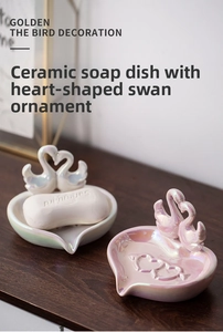 Detail of heart-shaped ceramic swan soap dish in pearl white and pink finish