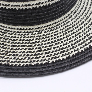 Macro shot of high-density black and white striped woven texture on summer straw hat