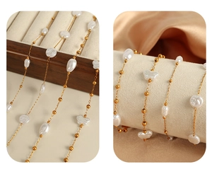 Detail of gold chain necklace with irregular pearls and butterfly charms on silk