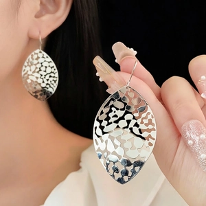 Hollow leaf-shaped silver metal drop earrings for women with elegant filigree design