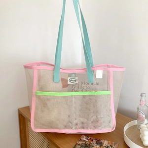 Large mesh beach tote bag in beige with pastel pink, blue, and lime green accents