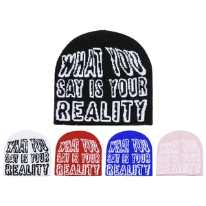 Detail of five colored knit beanies with jacquard lettering and soft textured fabric