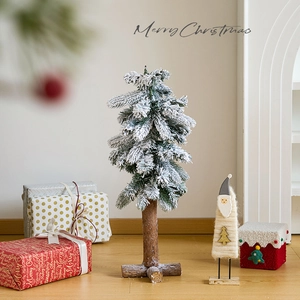 Miniature wooden Christmas tree with snow decoration and log base for holiday tabletop decor