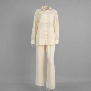 Detail of light yellow textured shirt and wide-leg trousers set with button closure