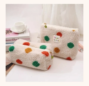 Plush lamb wool cosmetic bag with colorful polka dots and daisy flower zipper detail