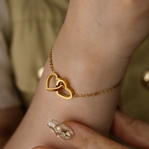 Minimalist double heart interlocking charm bracelet in polished gold stainless steel
