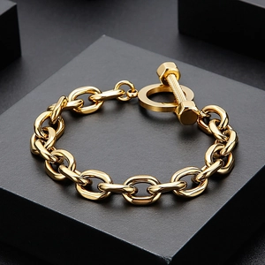 Macro view of gold stainless steel heavy chain bracelet with industrial bolt T-bar clasp