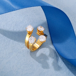 Detail view of 18K gold stainless steel open ring with four round zircon stones on blue ribbon